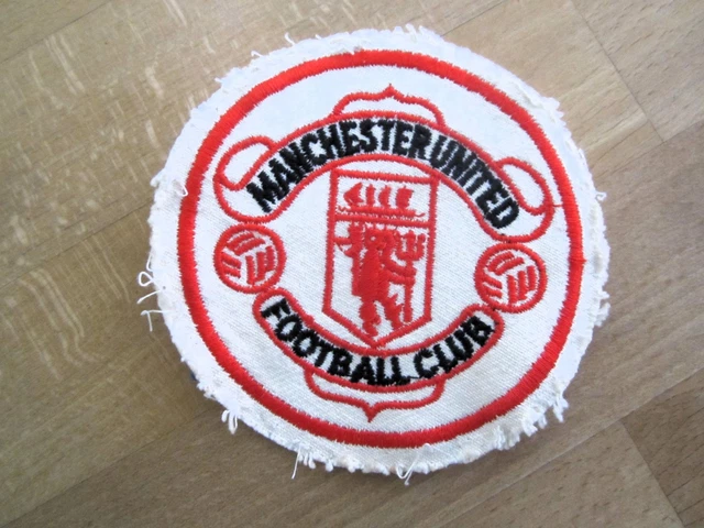 A red and white Manchester United official tour pennant, with