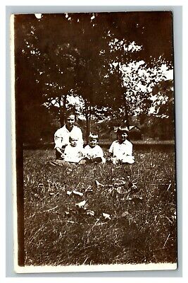 Vintage Early 1920's RPPC Photo of Young Family Sitting on Grass