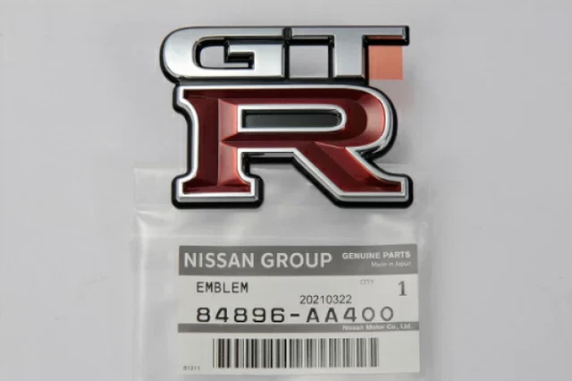 thumbnail image 2 of OEM Nissan Rear Trunk Emblem For R34 Skyline GTR (Late 01-02) – Genuine 90889-WF700 Chrome 2 of 3