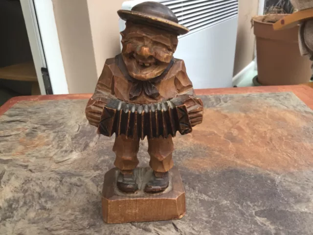 6” Carved wooden man plating an accordian