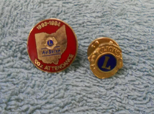 #D246.  Two(2)   Lions Club Lapel Badges - 100% Attendance 1993-94 Plus Tie Stud