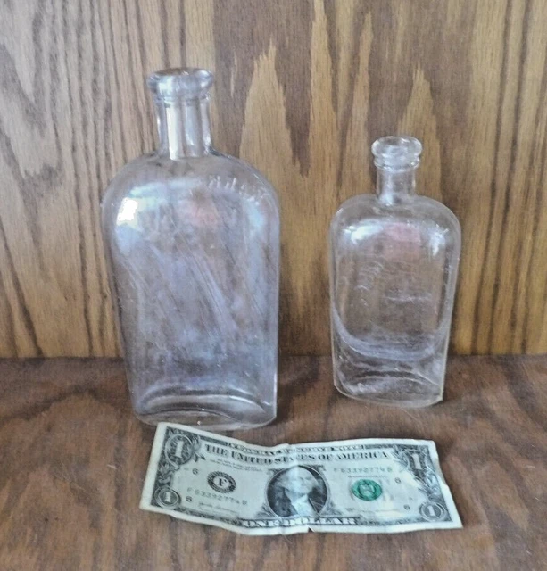2 ANTIQUE EMBOSSED GLASS WARRANTED FLASK BOTTLES - 7 and 9 oz