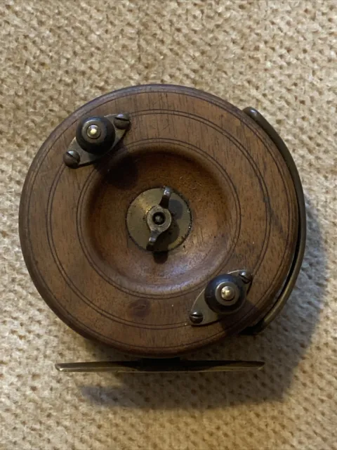 A VINTAGE BRASS SALMON FLY FISHING REEL BY ARMY & NAVY LONDON MAKER .