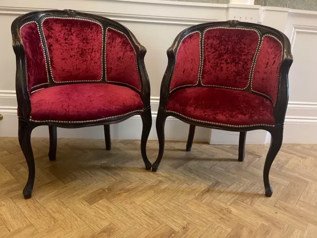 Pair of red velvet desk chairs, show wood frame with stud detailing