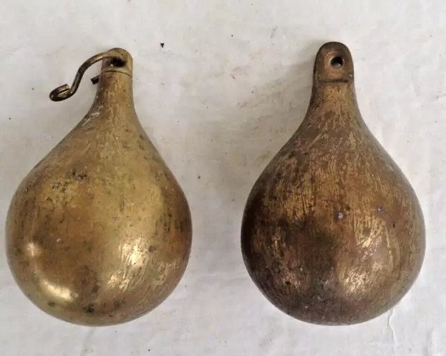 a pair of brass pear shaped clock weights