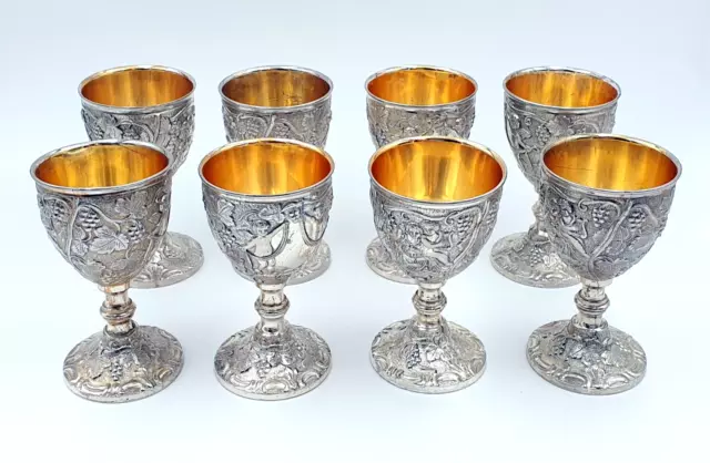 Set of eight silver plated drinking goblets with cast grape & vine decoration