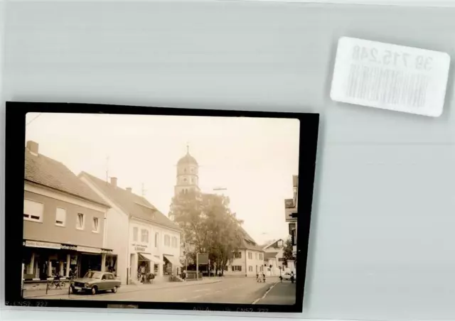 39715248 - 7918 Illertissen Strasse Kirche Auto Fahrrad Farben Ochs Handlung