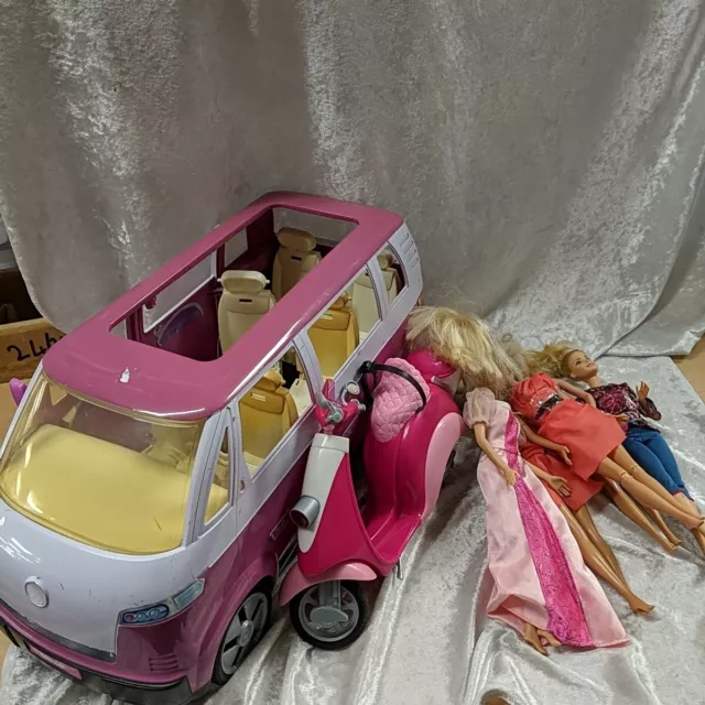 A Collection Of Barbie Toys Including Vehicles And Dolls