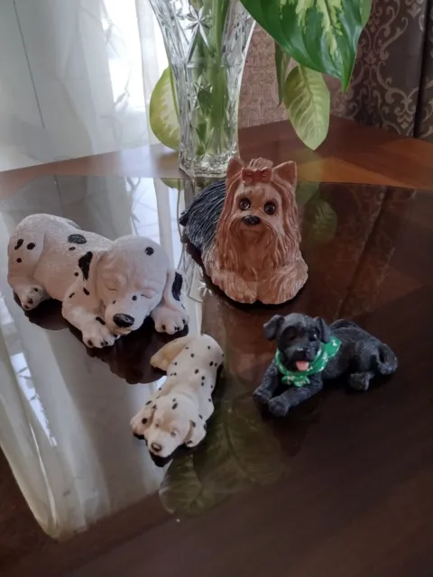 Lot of 4 vintage resin dog figurines.