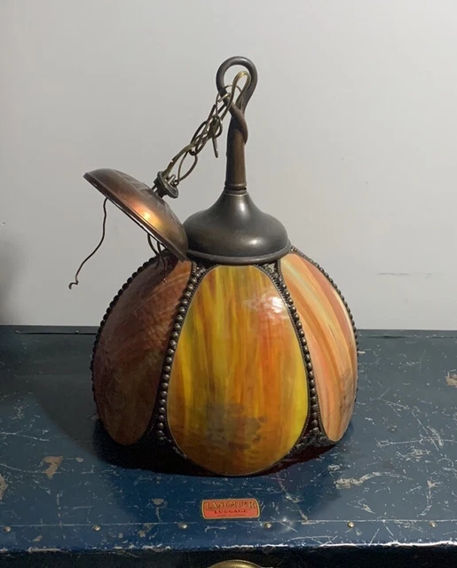 Arts and crafts era hanging slag glass light. Orange tones coloured glass shade
