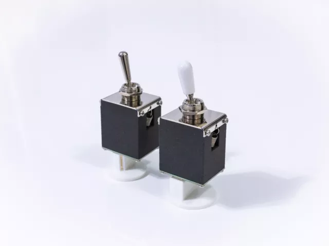 Magnetically held solenoid toggle switch