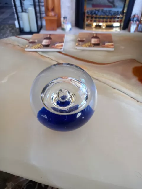 Large Circular Bubble Glass Paperweight With Dark Blue Base.
