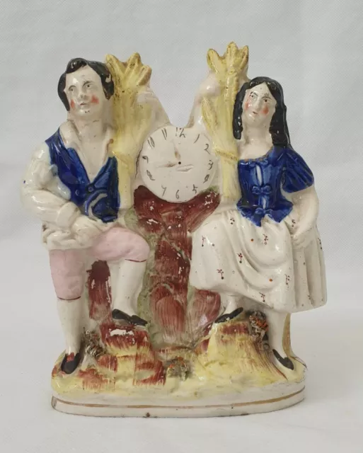 Antique Victorian Staffordshire Figure Groupe , Of A Couple Leaning on a Clock