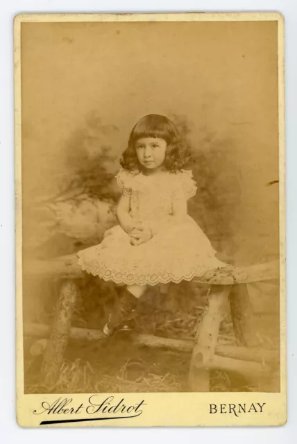 CABINET PHOTO Sidrot Bernay, little girl sitting on wooden table fashion dress