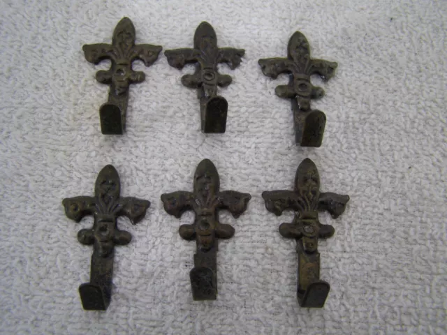 6 Small Vintage Fleur De Lis Hooks Hook part is bendable Not sure of purpose