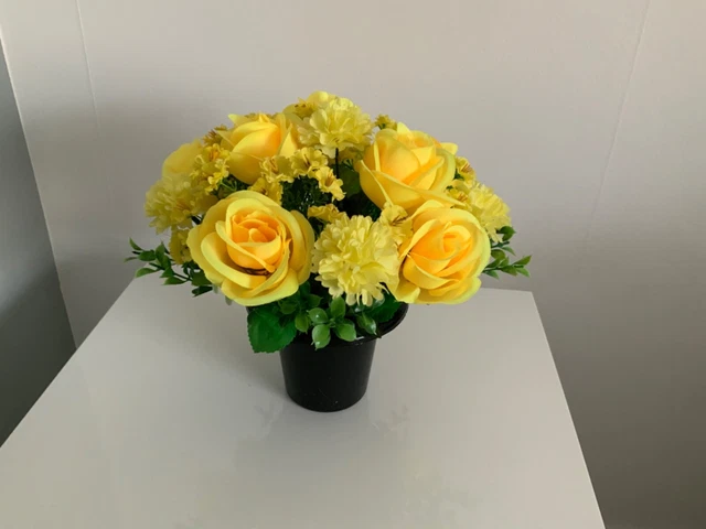 Beautiful artificial yellow flower arrangement in grave/memorial/crem pot