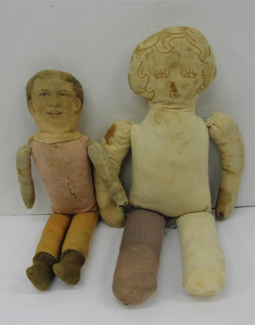 Two antique primitive rag dolls;boy-litho or painted face;girl-face handsewn