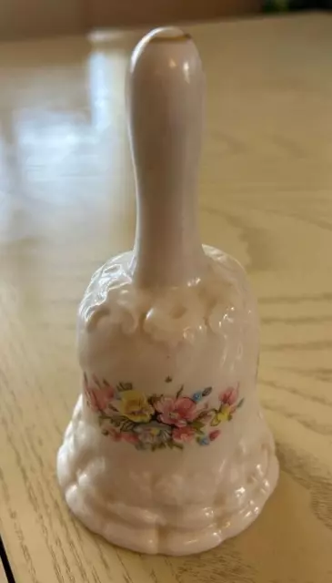 Vintage porcelain bell in ivory with dainty pink flowers; 5 1/2 " tall