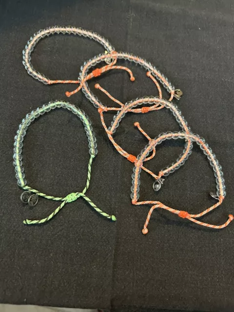 4 ocean bracelet lot.  Four Orange And One Green