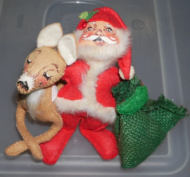 Annalee Santa with sack of toys in one arm and hugging reindeer with other arm