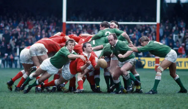Jerome Gallion of the WRU Presidents team tackles Terry Holmes of - Old Photo