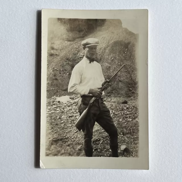 Vintage B&W Sepia Snapshot Photograph Young Man In Cap With Rifle Gun