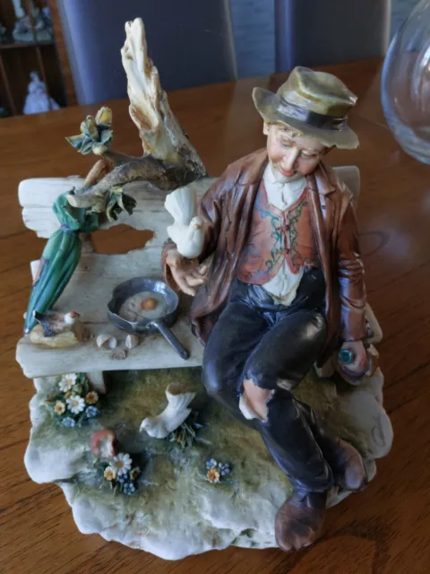 Capodimonte figurine tramp on bench with birds