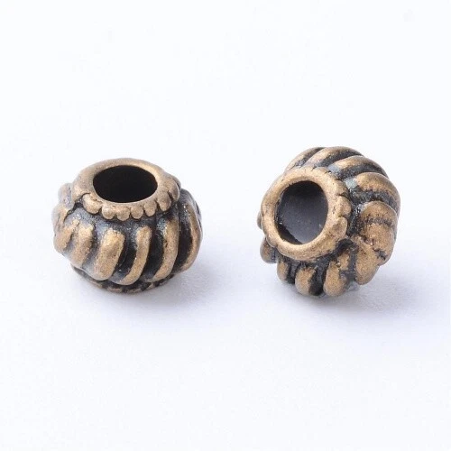 20 tibetische Metallperlen antik bronzefarben 6,5 x 4,5 mm