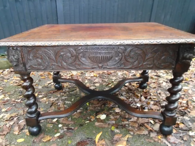 Antique library table with beautiful carvings and leather top