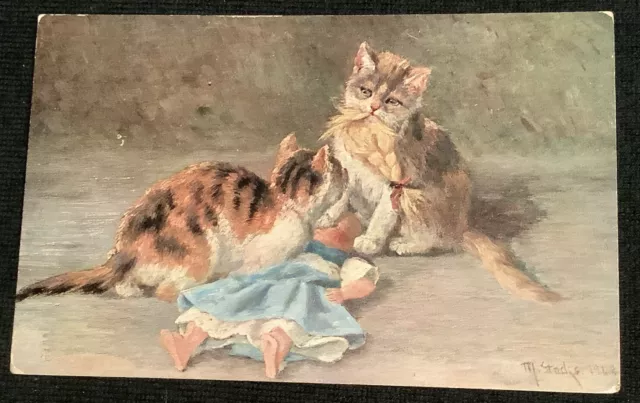 2 Cats Kittens Playing With Toy Doll Vintage Postcard Artist:  M. Stacks