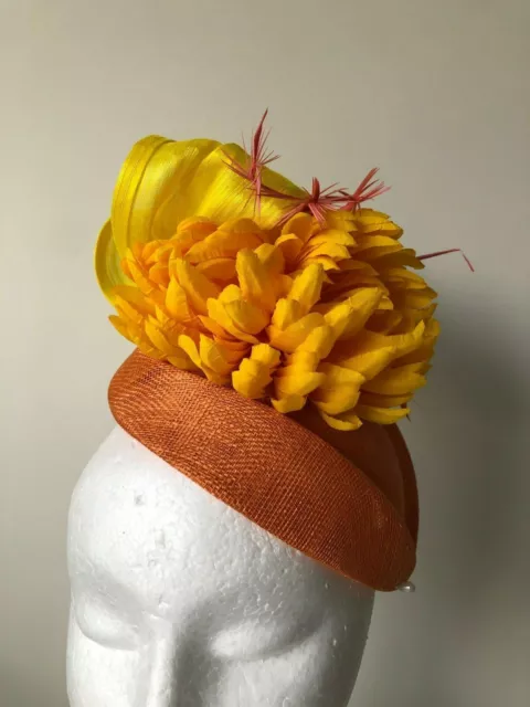 New Orange air hostess fascinator with yellow loops, flower and feathers!