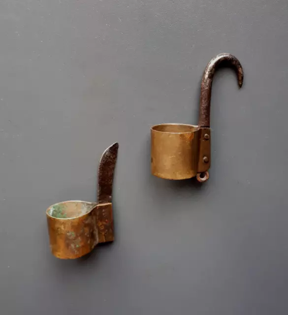 Two early 19th century brass and steel miner's leather helmet candleholders.