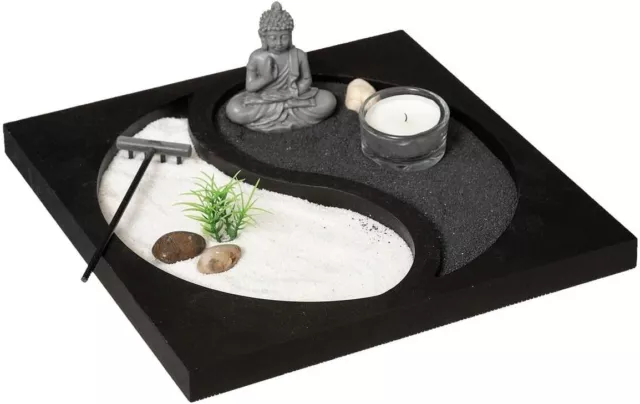 Meditationsset mit einer Buddha-Figur und einer Kerze Dektrotive Buddha-Figur