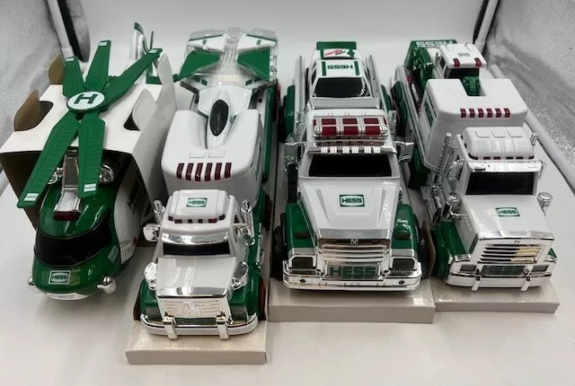 LOT of (4) Hess Holiday Toy Truck Tractor Race Car Jet Helicopter Rescue Trucks