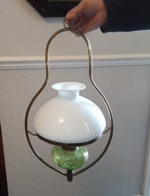 Antique hanging oil lamp. Green glass with gold detail.  Brass frame. 