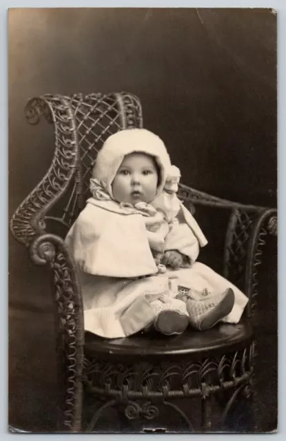 RPPC Portrait Postcard~ Bundled Up Infant Child Sitting In Wicker Chair