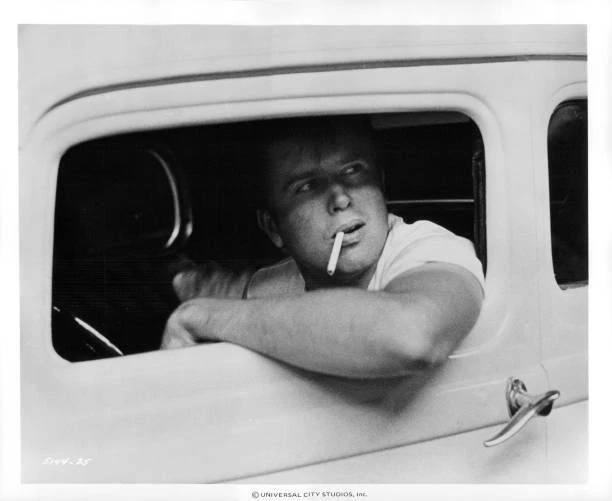 PAUL LE MAT with a cigarette in his mouth looking out of the car w Old