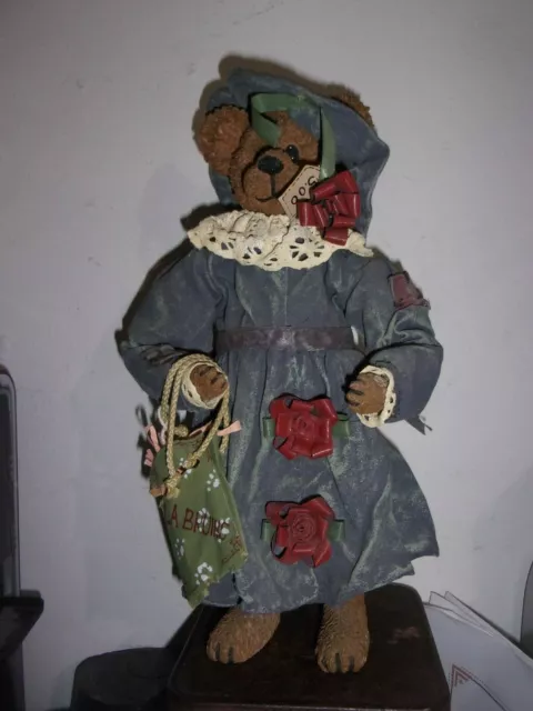 12" Resin Bear with heavily starched clothes carrying a present 2648