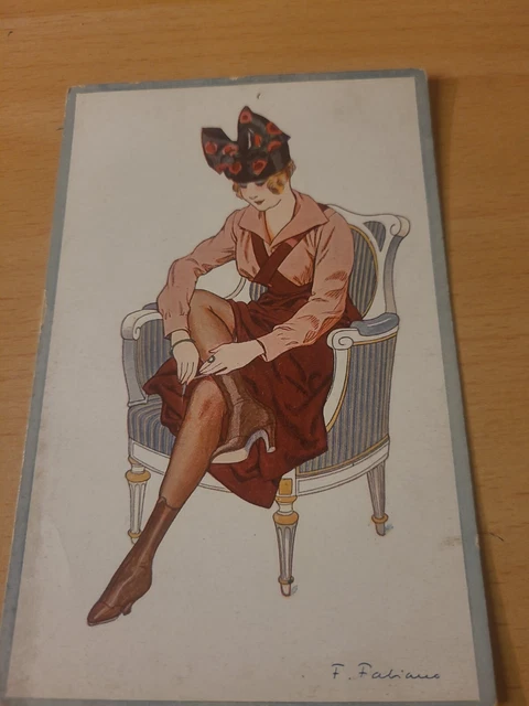 CPA ILLUSTRATEUR SIGNE jeune femme accrochant son bas