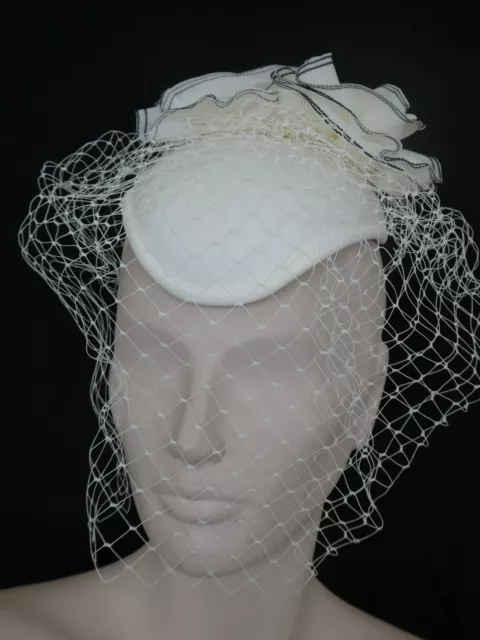 Vintage fascinator hat ivory and navy blue whirls lots of netting.