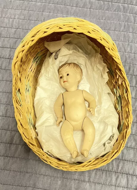 vintage wicker baby bassinet with porcelain articulated baby doll
