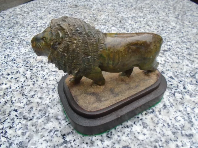 Hardstone well carved lion great character some age on a hardwood stand