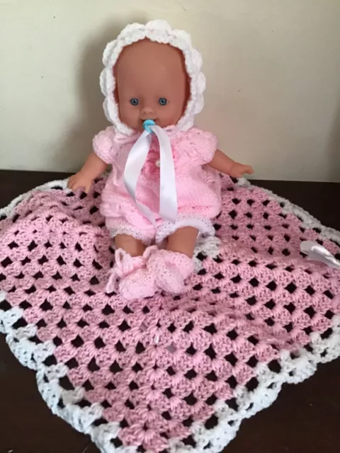 12. inch baby doll   soft body.  dressed in hand knitted outfit/ blanket. dummy