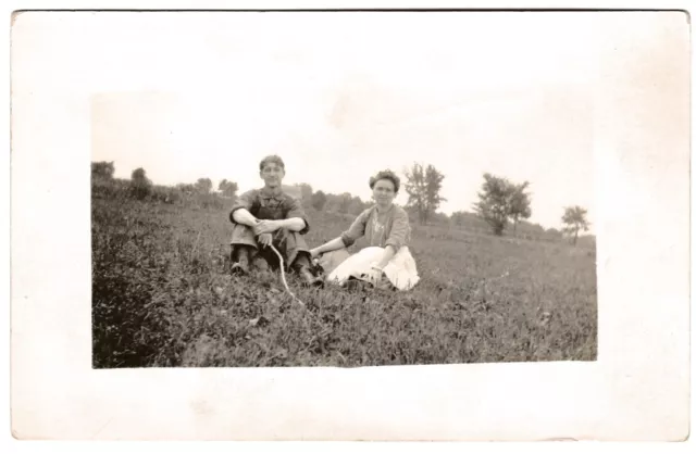 Rppc - Young Romantic Couple in Early Period Attire Sitting in a Field Vtg PC