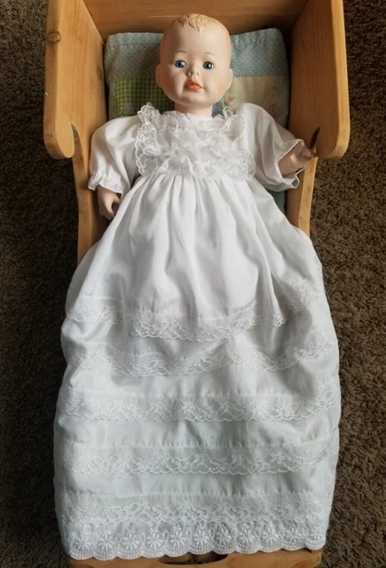 Vintage bisque porcelain baby doll in christening gown