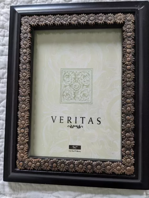 Picture frame. 5"x 7" Veritas . Beautiful bronze color metal flowers surround...