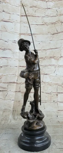 Bronze sculpture depicting a Boy fisherman throwing his line into the water