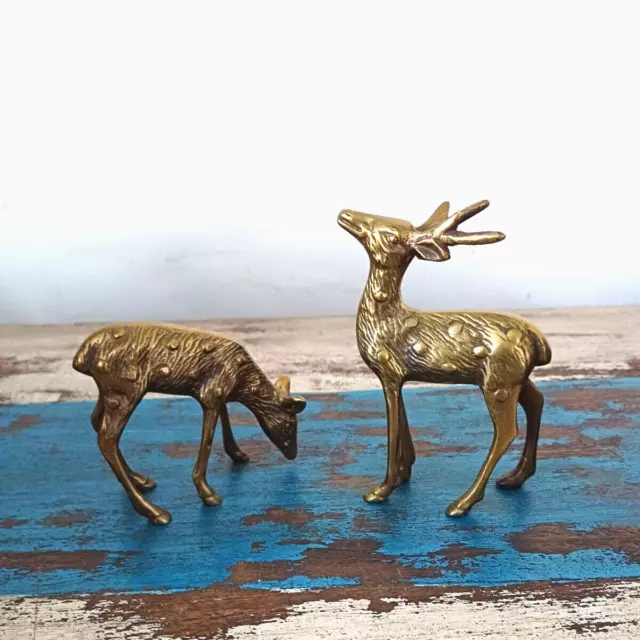 A pair of mid 20th century brass stag and doe spotted deer