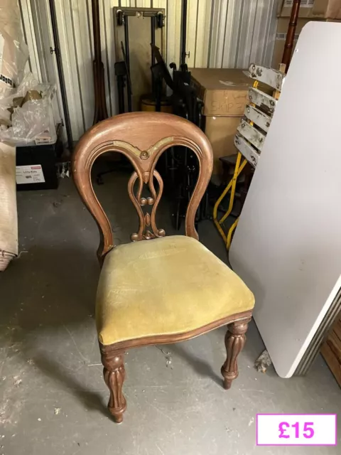 Antique wooden chair with green/yellow upholstered seat