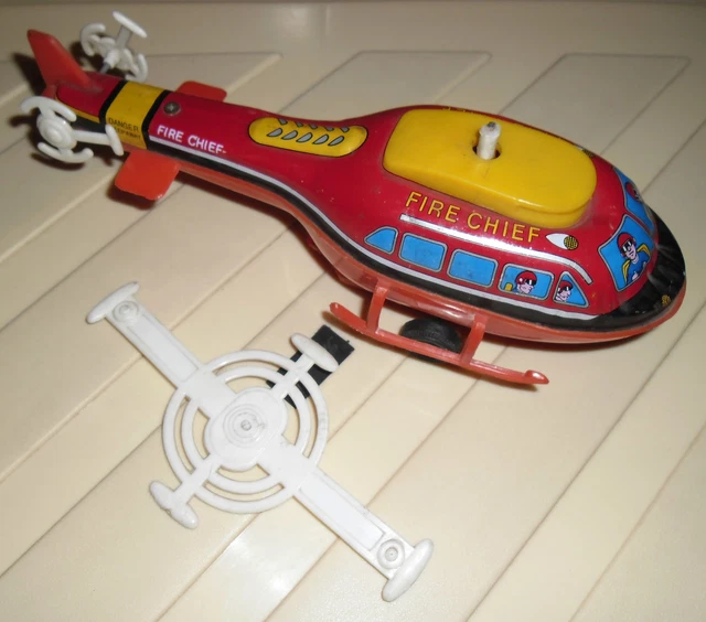 1 VINTAGE TIN Toy Helicopter Fire Chief Spring Load Can Fire Helicopter